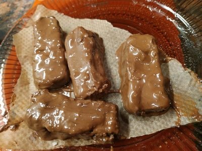 Place a baking paper on a tray or plate and add the chocolate patties milk chocolate Homemade Bounty Bars