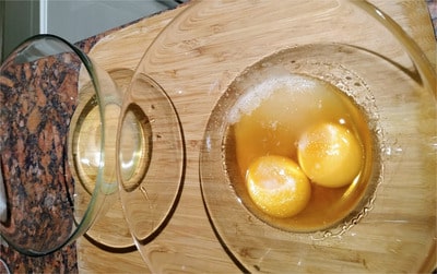 separate the eggs in two bowls and add the brandy and sweetener on top of the egg yolks Sugar Free Tiramisu